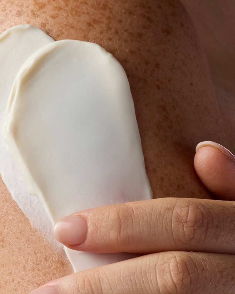 Applying smooth, cruelty-free skincare cream to skin, promoting a natural and cruelty-free lifestyle for dog mums.