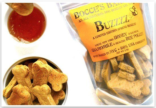 Bocce's Bakery limited edition spring dog biscuits with honey and chamomile next to a bowl of bone-shaped treats.