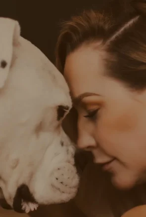 A woman nose to nose with her old dog